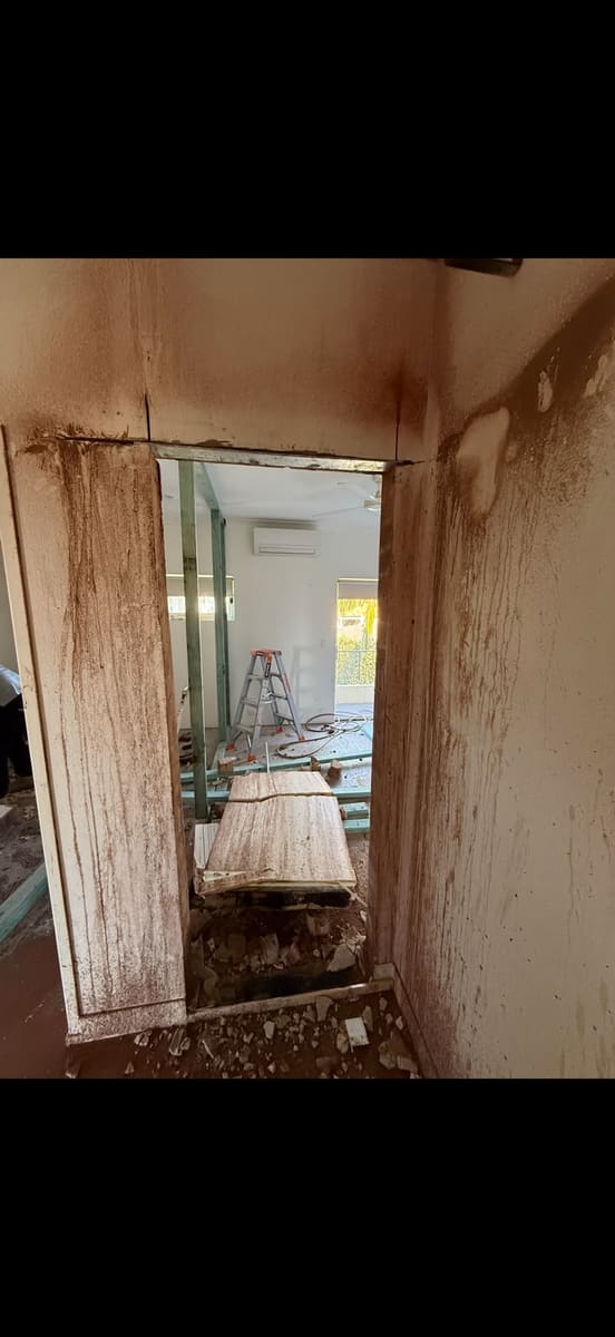 New doorway opening cut through a rendered wall
