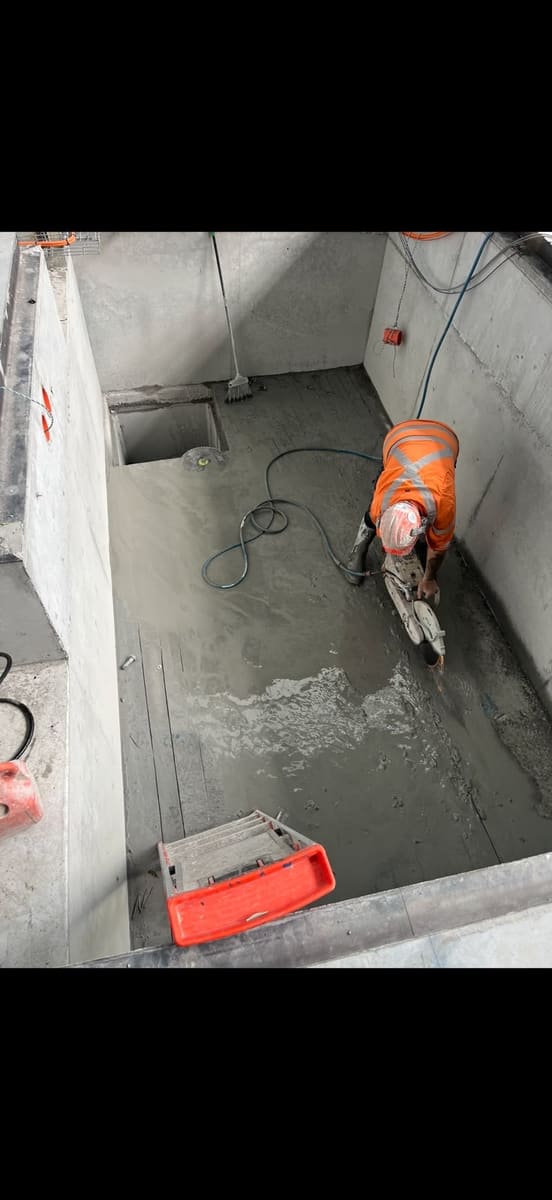 Floor sawing a concrete slab inside a bathroom