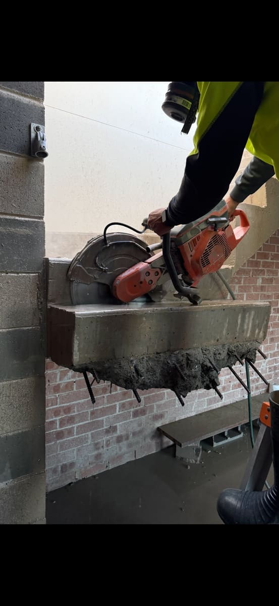 Hand sawing concrete at height on site