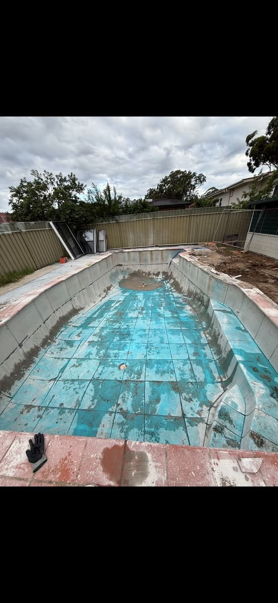 Empty concrete pool marked and cut into sections for removal