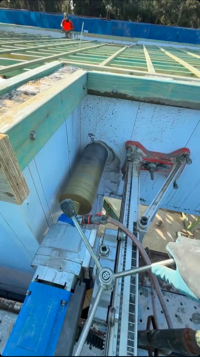 Large saw blade set up inside a concrete pool for demolition cutting