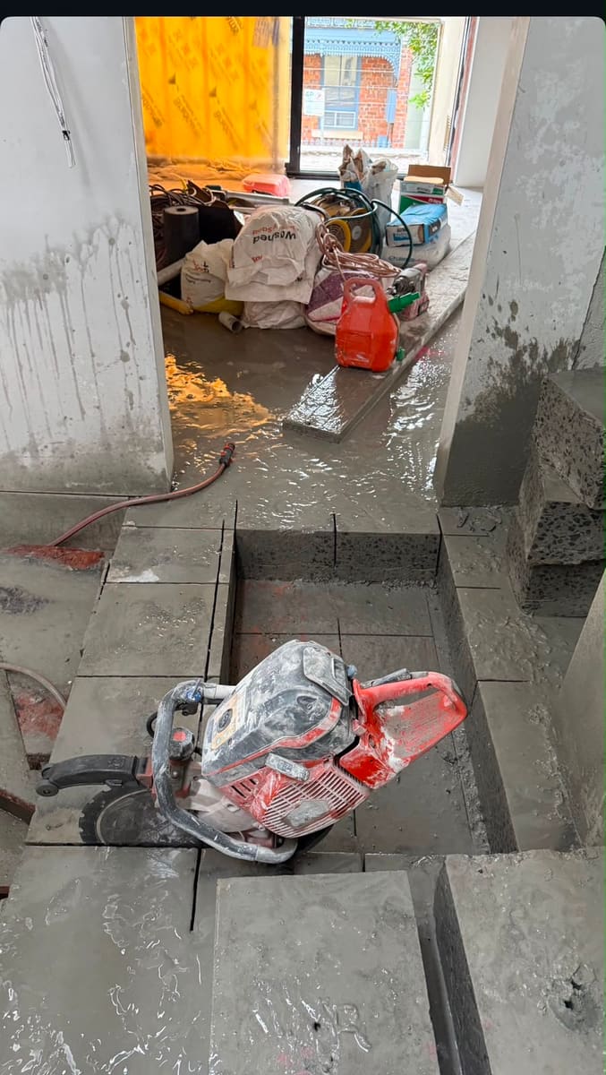Opening cut through a tiled concrete floor