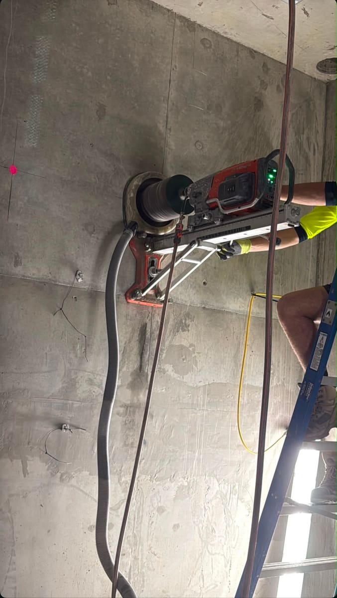 Core drilling rig mounted high on a concrete column