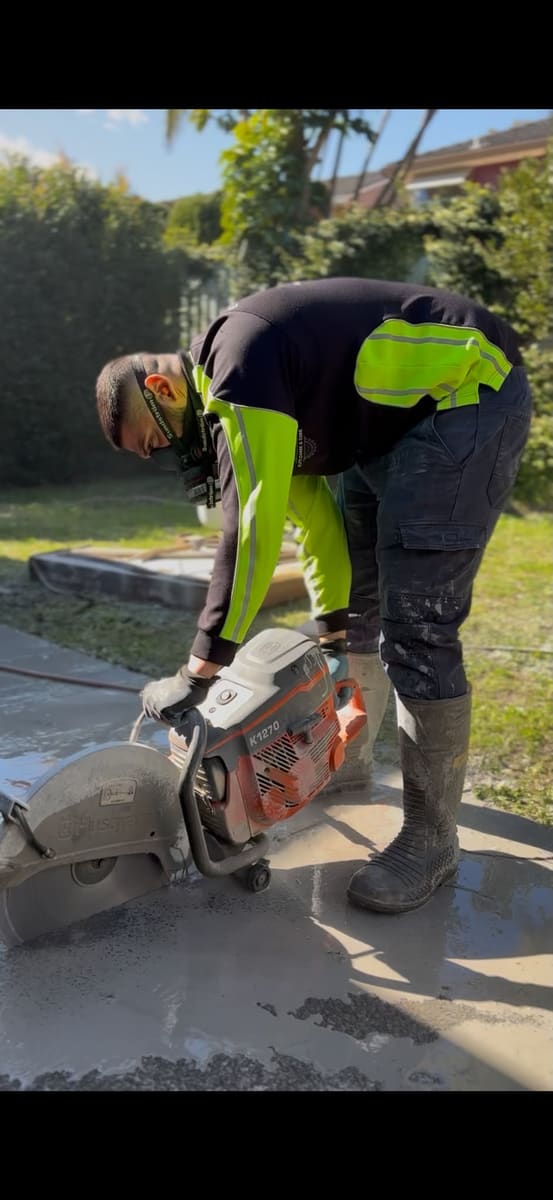 Road sawing a concrete driveway with a cut-off saw in Sydney