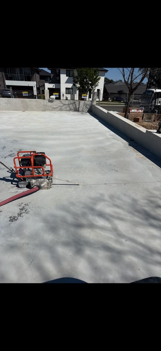 Road saw cutting a straight line through an outdoor concrete slab