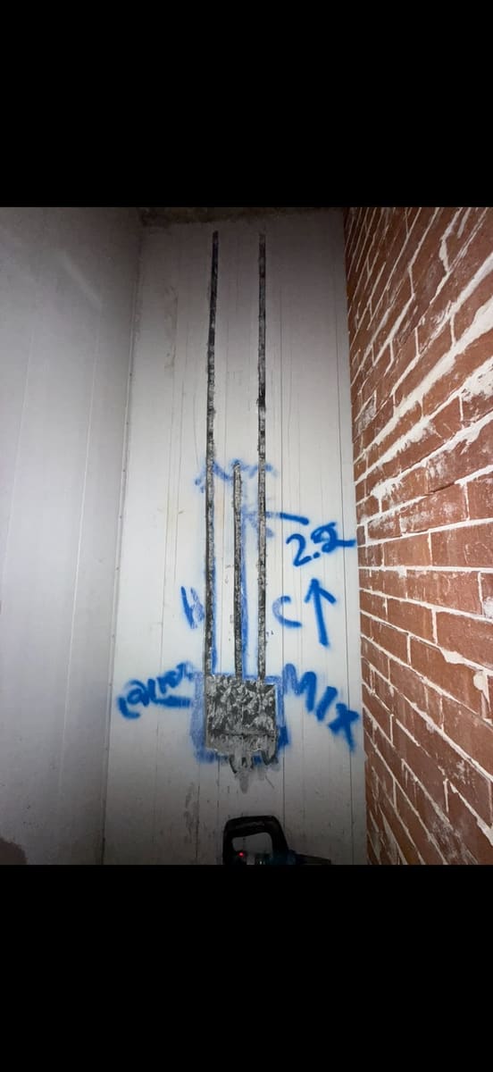 A wall chase cut to depth for conduit, marked out before cutting